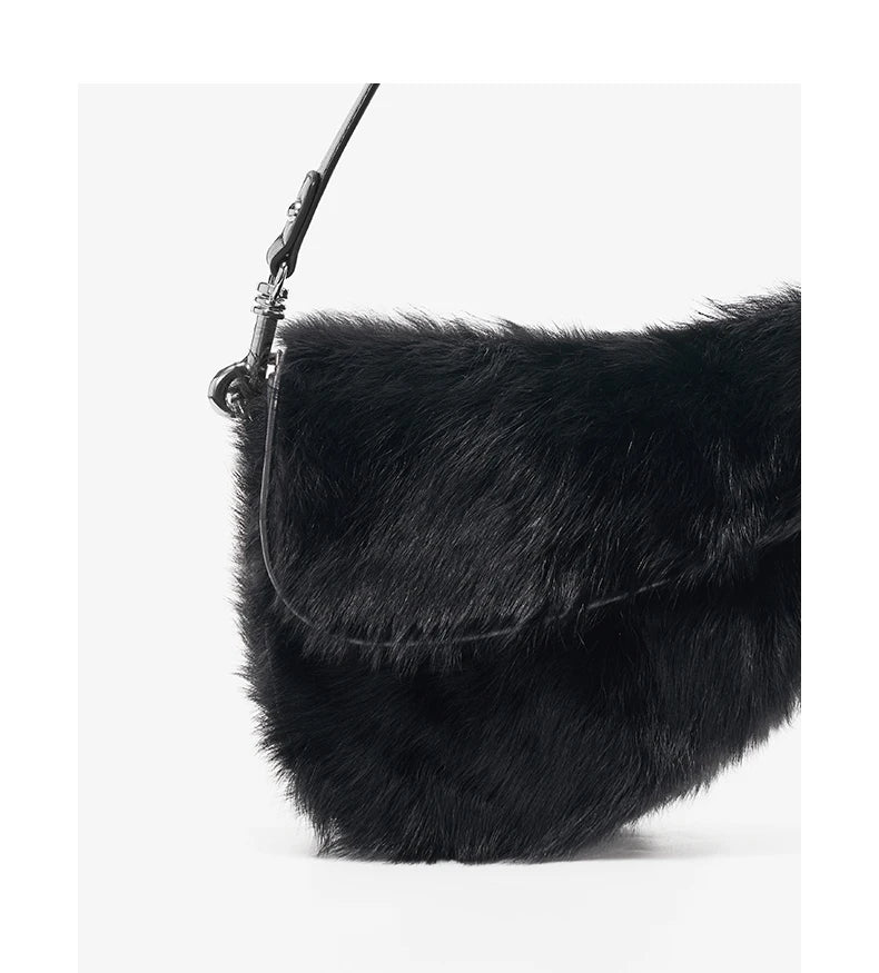 Black fur handbag on a white background