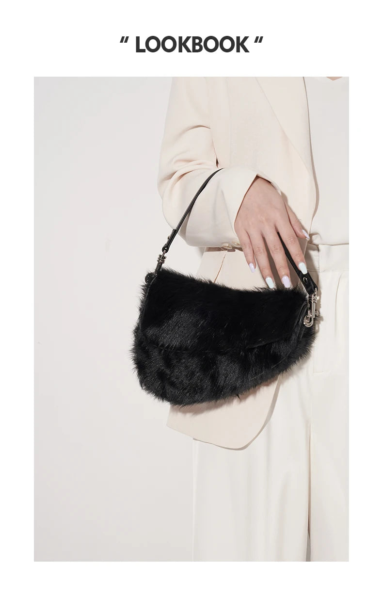 Black fur handbag held by a person wearing a beige coat
